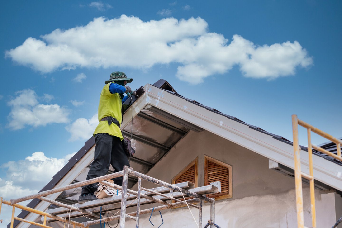 Construction worker install new ceramic tile roof, Roofing tools, Electric drill used on new roofs on construction site.; Shutterstock ID 1892112883