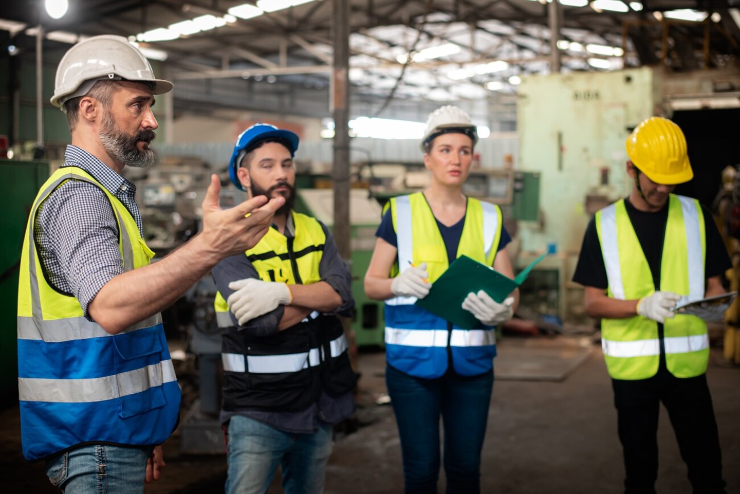 Professional Caucasian manager engineer in safety uniform is training industry factory worker, workshop factory operator, mechanical engineering team production in heavy industrial manufacture factory; Shutterstock ID 2149854693