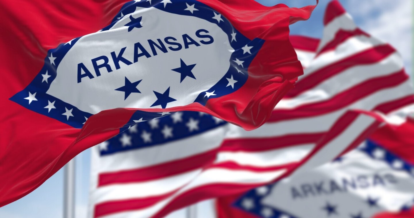 The flags of the Arkansas state and United States waving in the wind. Democracy and independence. US state flag; Shutterstock ID 2162160889