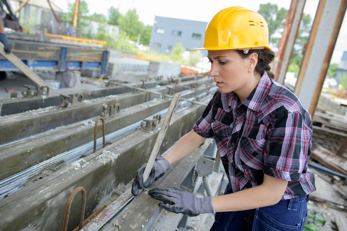 Female builder at work on site; Shutterstock ID 732813775