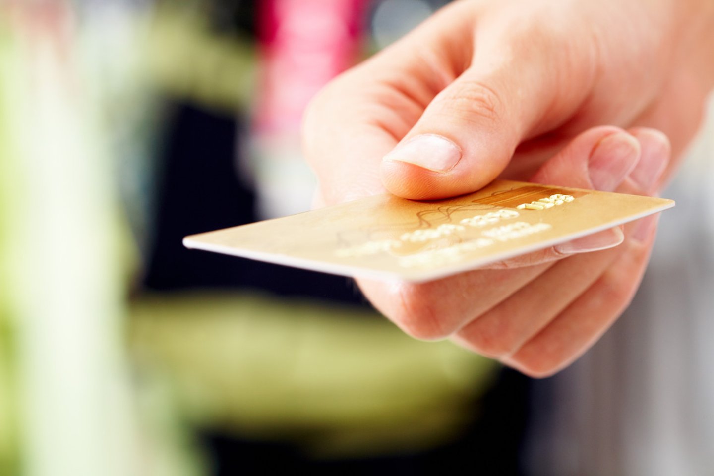 Close-up of credit card in human hand in the shop; Shutterstock ID 51417604