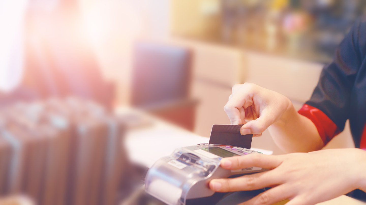 Moment of payment with a credit card through terminal.monochrome; Shutterstock ID 680478397