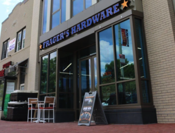 a sign above a store in a brick building