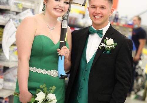 a woman standing next to a man in a suit and tie
