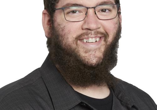 a man wearing glasses posing for the camera