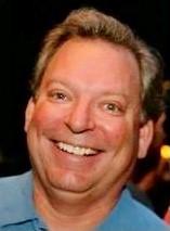 a close up of a man smiling for the camera