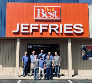 a group of people standing in front of a sign