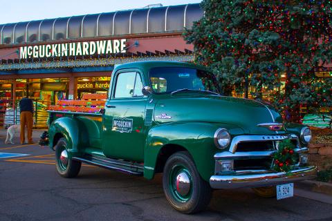 a green truck parked in front of a building