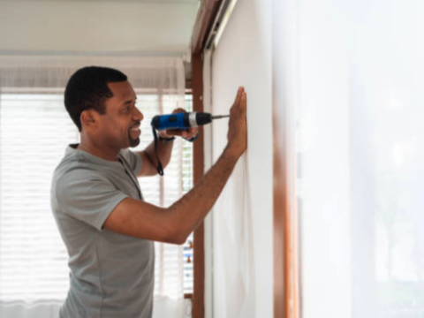 a man standing in front of a window