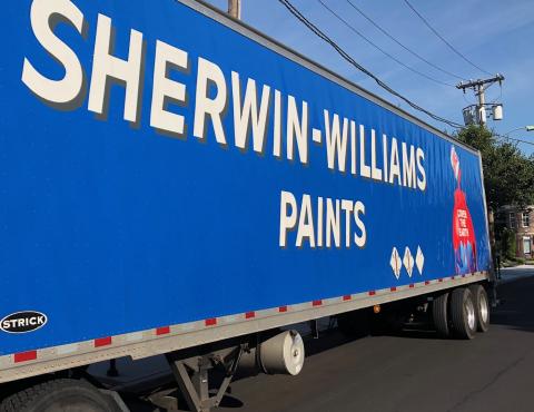 a blue truck parked on the side of a road