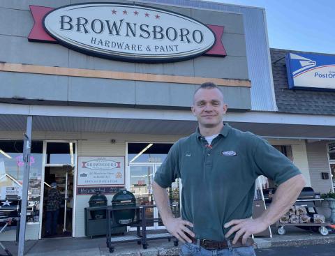 Doug Carroll a man standing in front of a sign