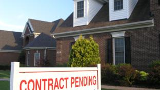 a sign in front of a house