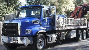 a blue truck parked on the side of a road